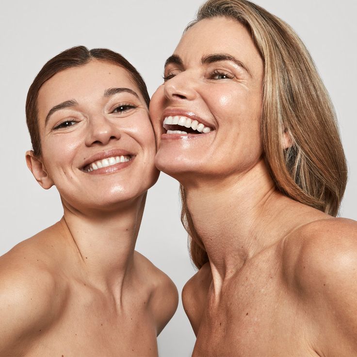two women of different ages smiling and showcasing their different skin textures 